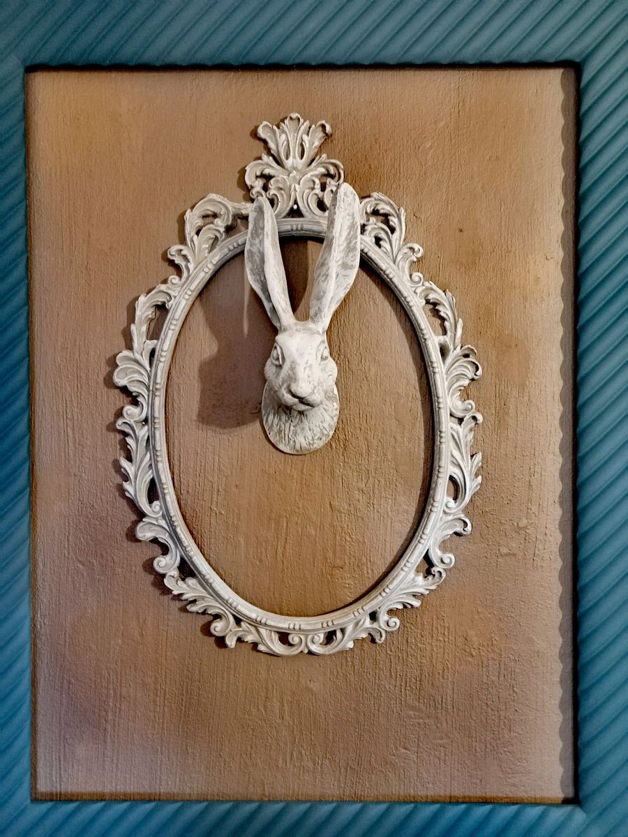 Hare head mounted in an ornate oval wall frame