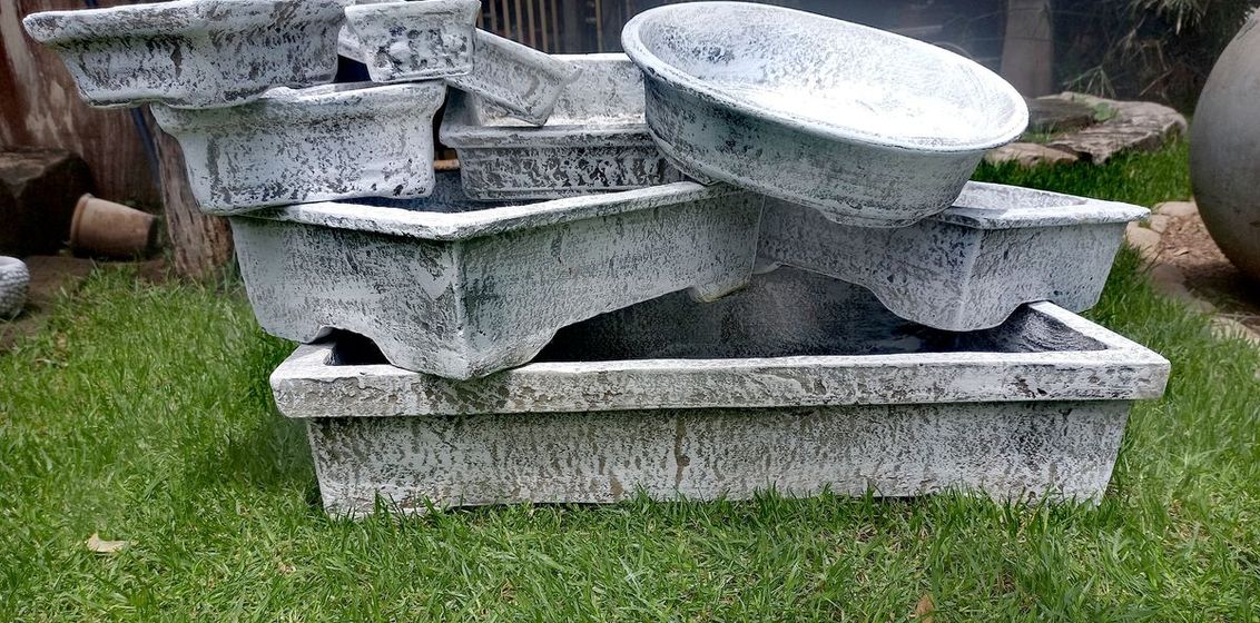 Tiered concrete water feature on a lawn